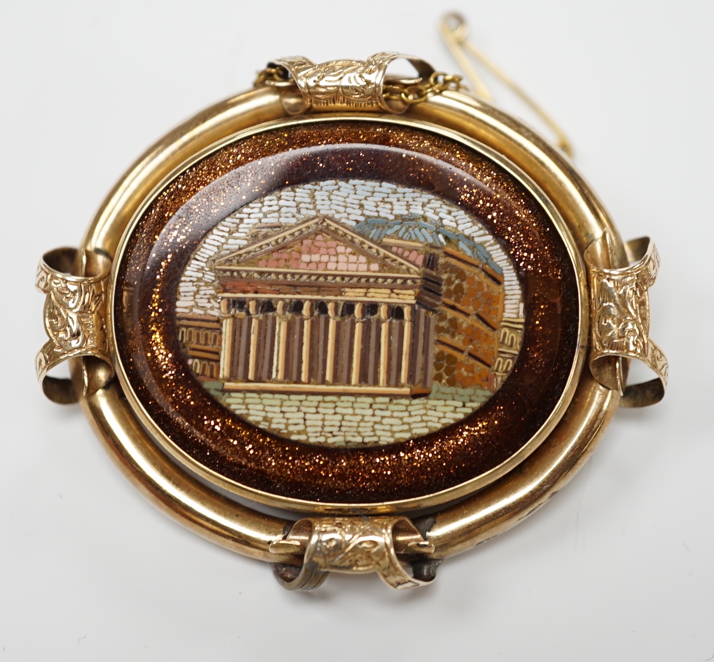 A Victorian yellow metal mounted goldstone and micro mosaic set oval brooch, decorated with the Pantheon, 49mm, gross weight 21.9 grams.